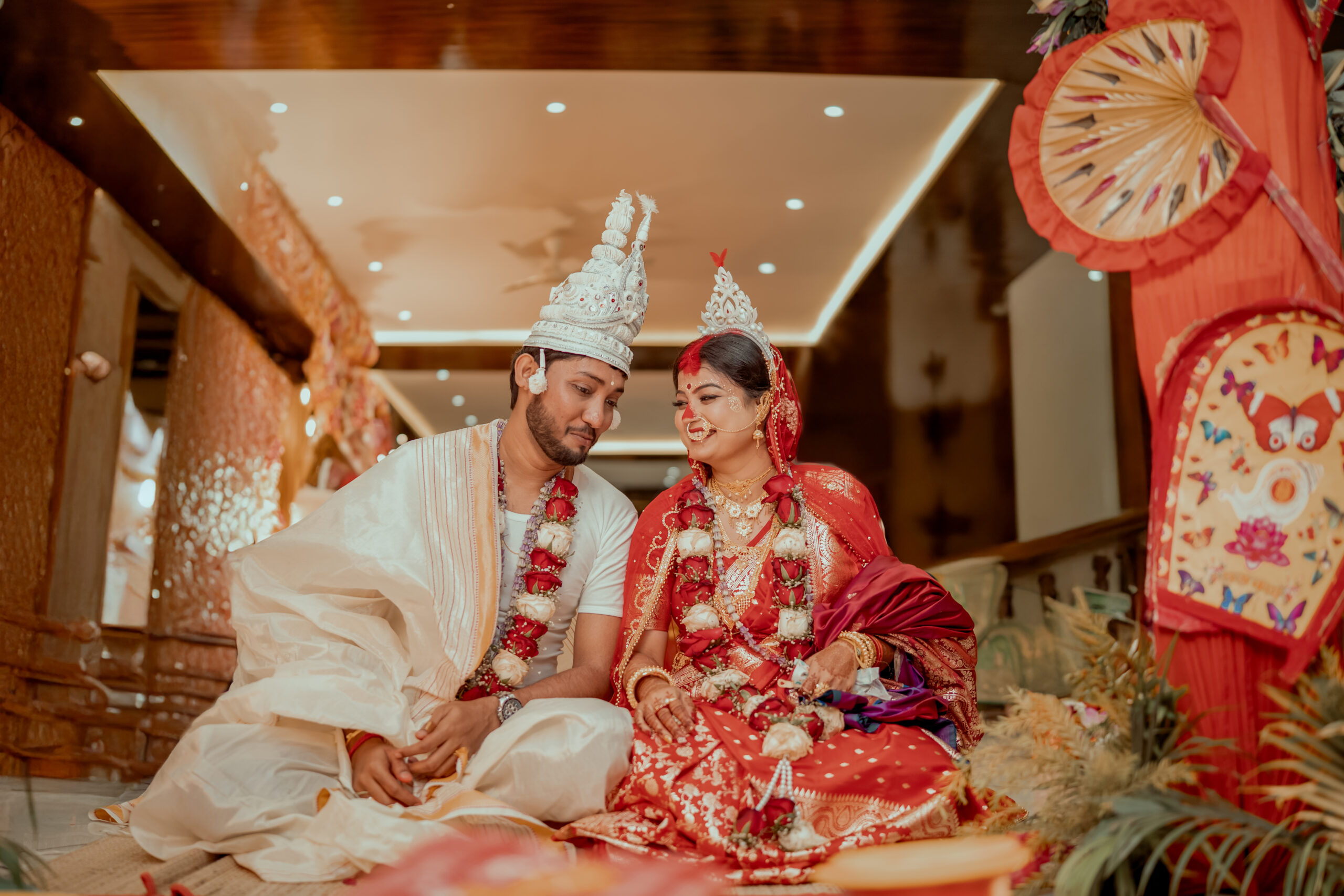 Bengali bride and groom celebrating together in traditional wedding attire