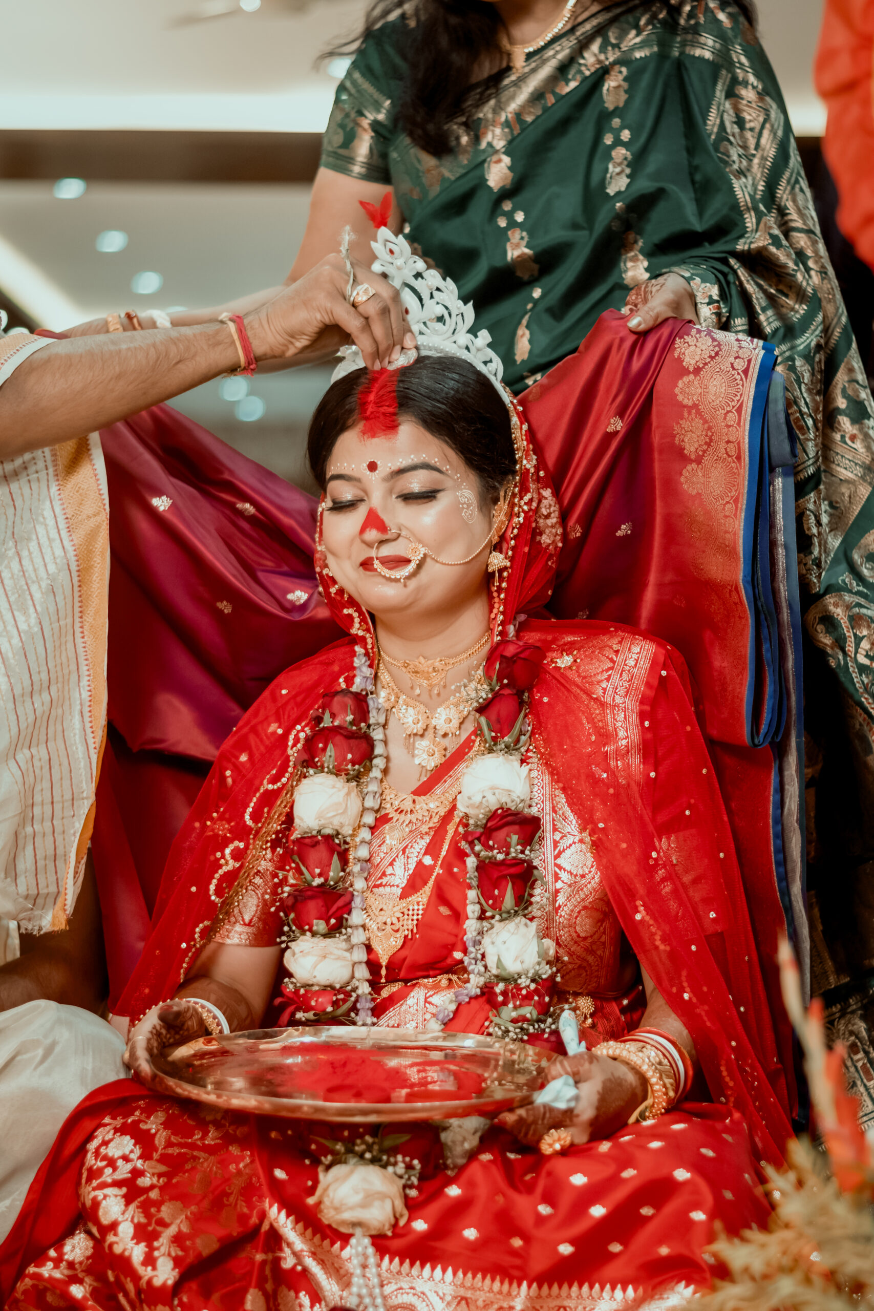 Bengali wedding ritual with a bride wearing a traditional white crown